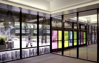 Lobby of the Geisel Library featuring the work of John Baldessari, transparent images of books and students melded to the windows.